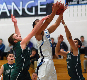 Ralston Valley senior Zac Stevens, middle, goes up for a shot as Pine Creek seniors Derek Keirns, left, and Joey Black knocks the ball loose Wednesday night in the opening round of the Class 5A boys basketball state tournament. (Dennis Pleuss)