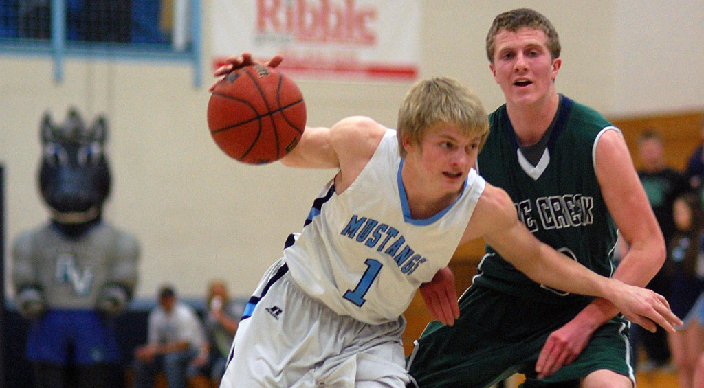 Ralston Valley junior Andrew Wingard (1) drives past Pine Creek junior Jared Savage during the first half Wednesday night. Wingard finished with 14 points in the Mustangs’ 72-54 victory. (Dennis Pleuss)